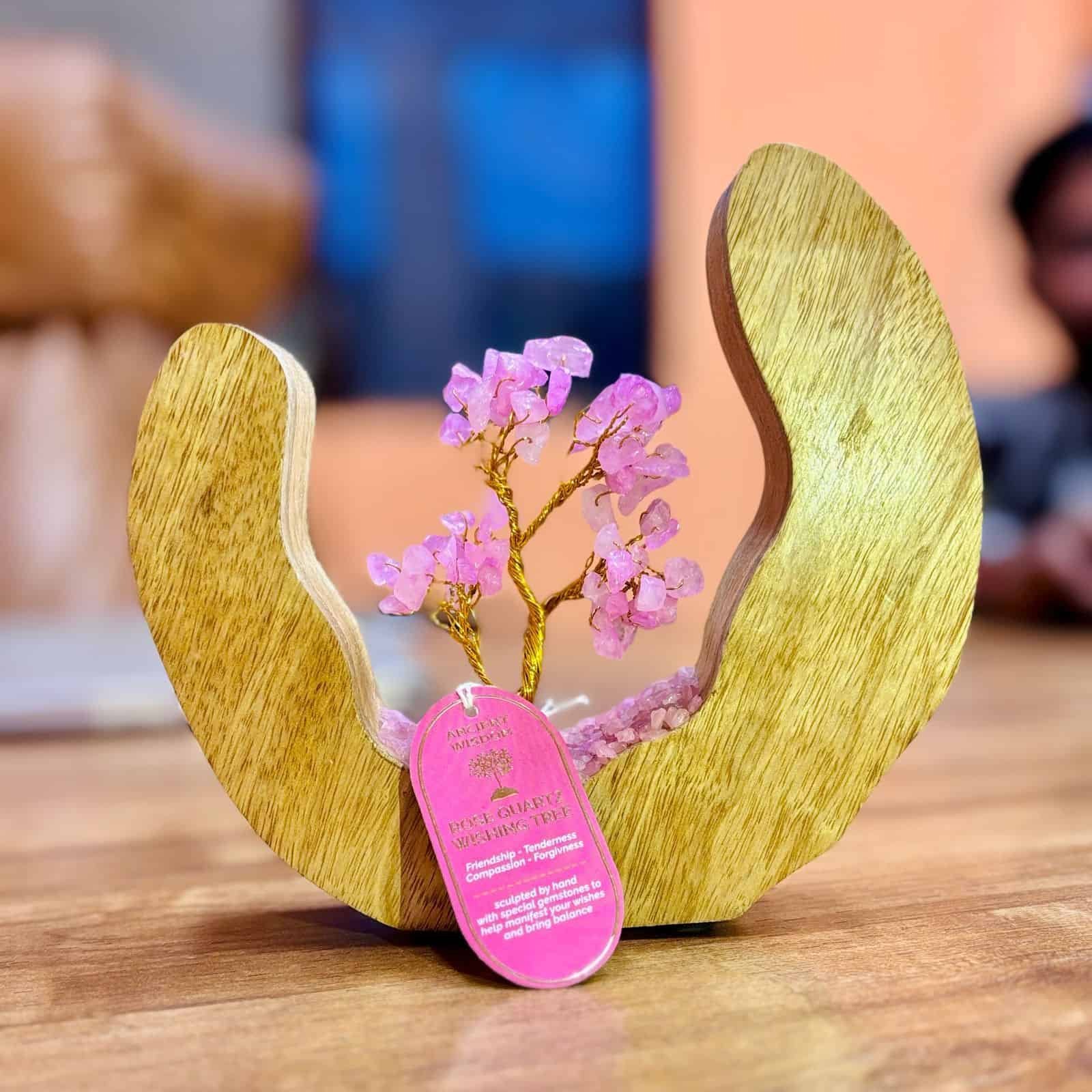 Vibrant pink gemstone wishing tree sculpture in a wooden heart-shaped cradle, symbolising friendship, compassion, and forgiveness, perfect as a heartfelt gift from Sunshine Gifts.