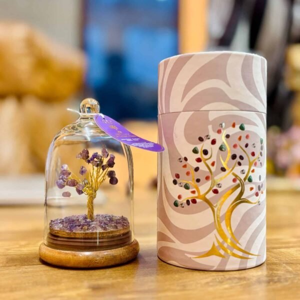 Purple gemstone tree inside a glass dome, next to a decorative cylindrical container with a colourful tree design, ideal as a handmade gift or keepsake from Sunshine Gifts.