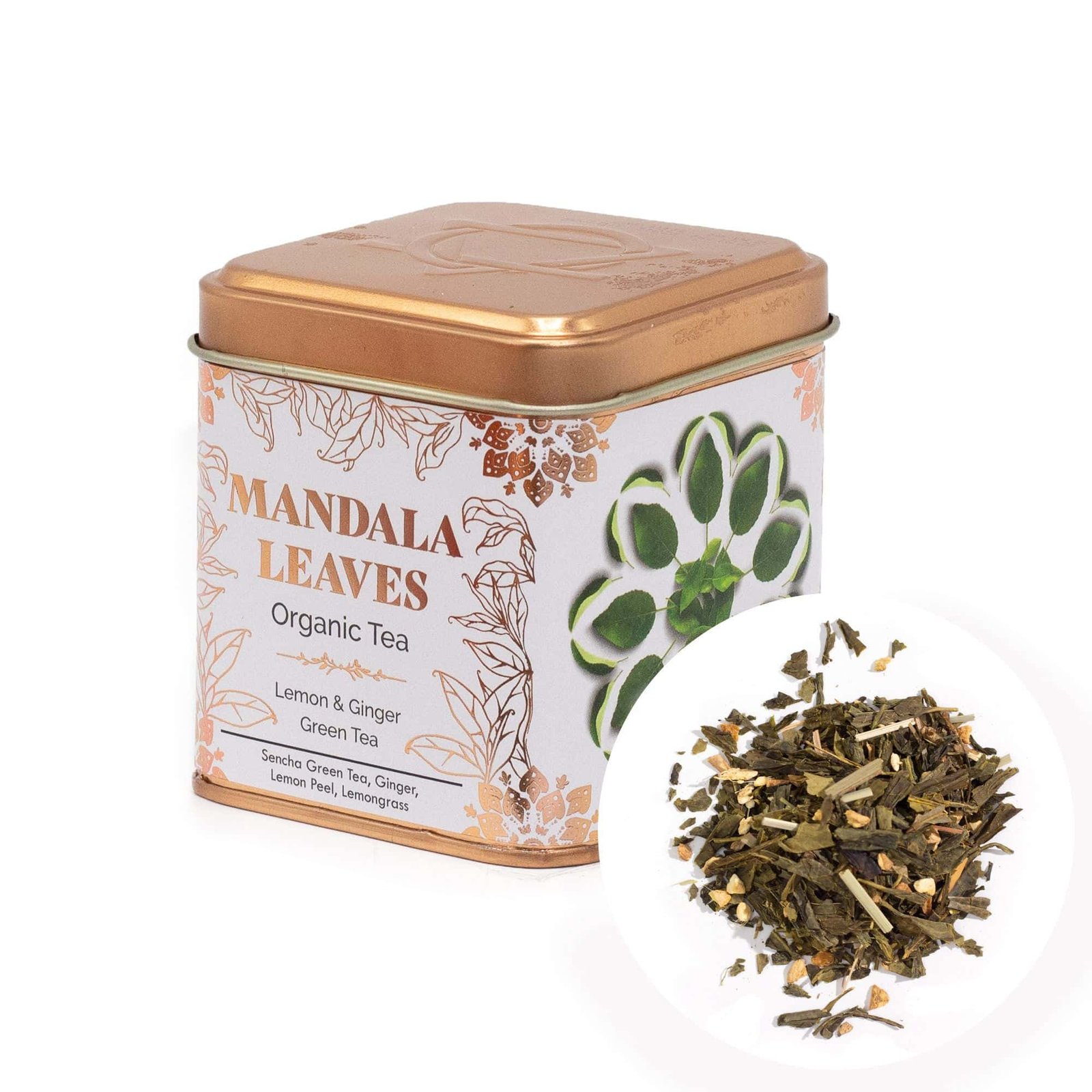 An image of a square metal tin containing Mandala Leaves Organic Tea, featuring a green and white mandala design on the packaging. A close-up of loose tea leaves is also shown.