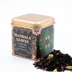Decorative tin of Mandala Leaves loose tea with black magic blend, featuring green leaves and herbal ingredients, ideal for tea lovers and gift sets.