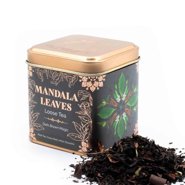 Decorative tin containing Mandala Leaves loose tea with dark brown magic blend, black tea, cocoa scent, and white chocolate notes, perfect for tea lovers.