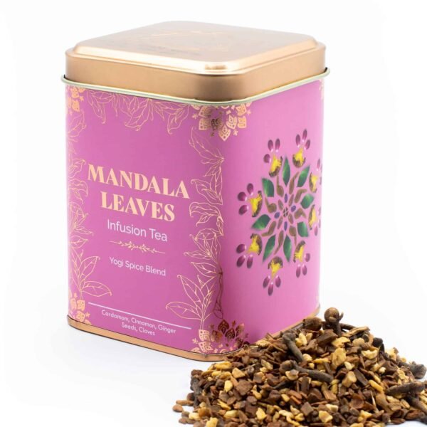 Decorative pink tin of Mandala Leaves infusion tea with a floral cut-out design, featuring a blend of spices and herbs including cardamom, cinnamon, ginger, seeds, and cloves.