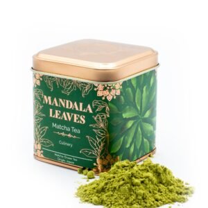 Green Mandla Leaves Matcha Tea in decorative tin with loose powder spilled, highlighting natural Japanese green tea.