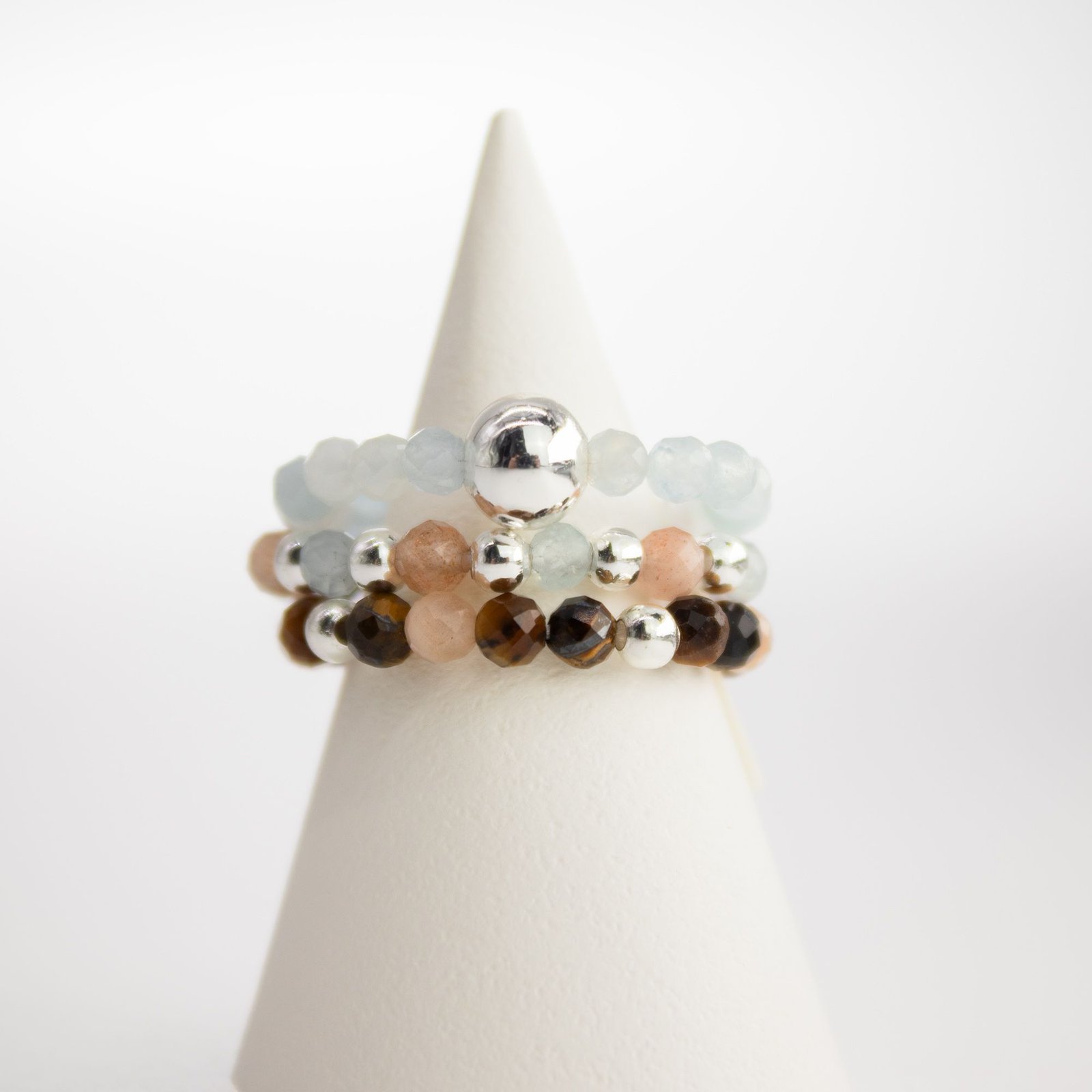 Sea Sunset gemstone rings displayed on jewellery stand