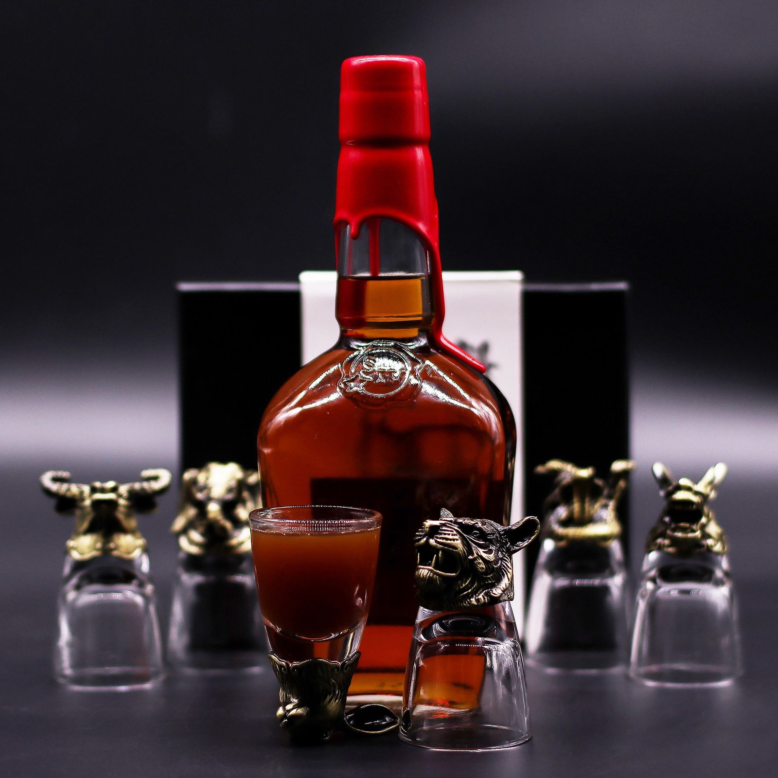 Mystical Creatures 50ml shot glasses displayed with a bottle of spirits